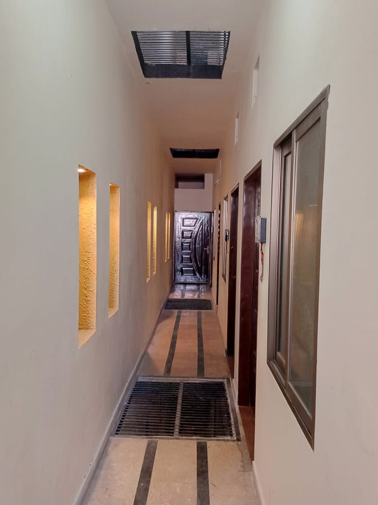 Illuminated Hallway with Warm Wall Niches at The Second Home Boys Hostel Lahore